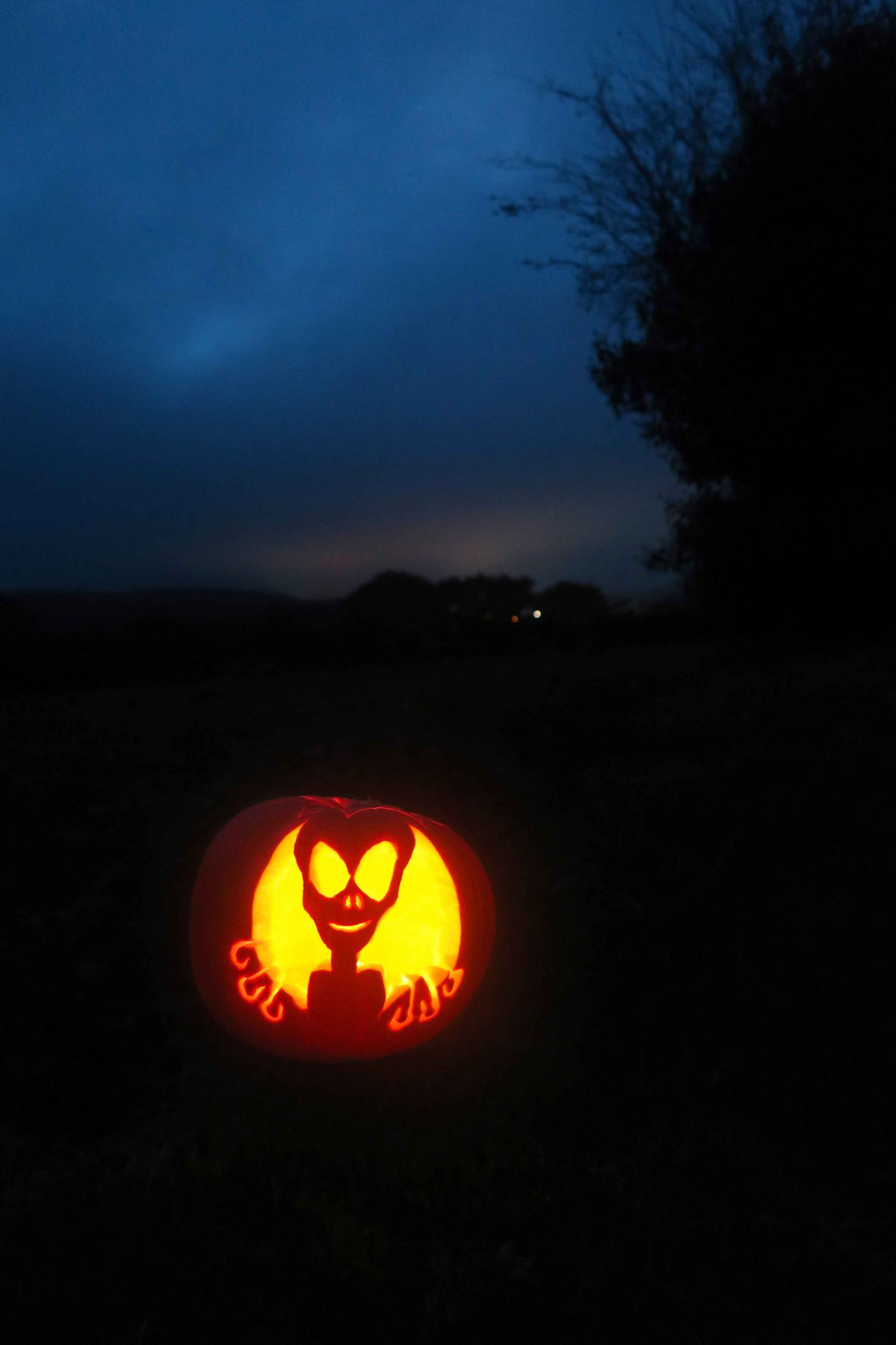 alien pumpkin carving at night
