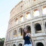 melissa carne standing in front of the colosseum in rome in italy