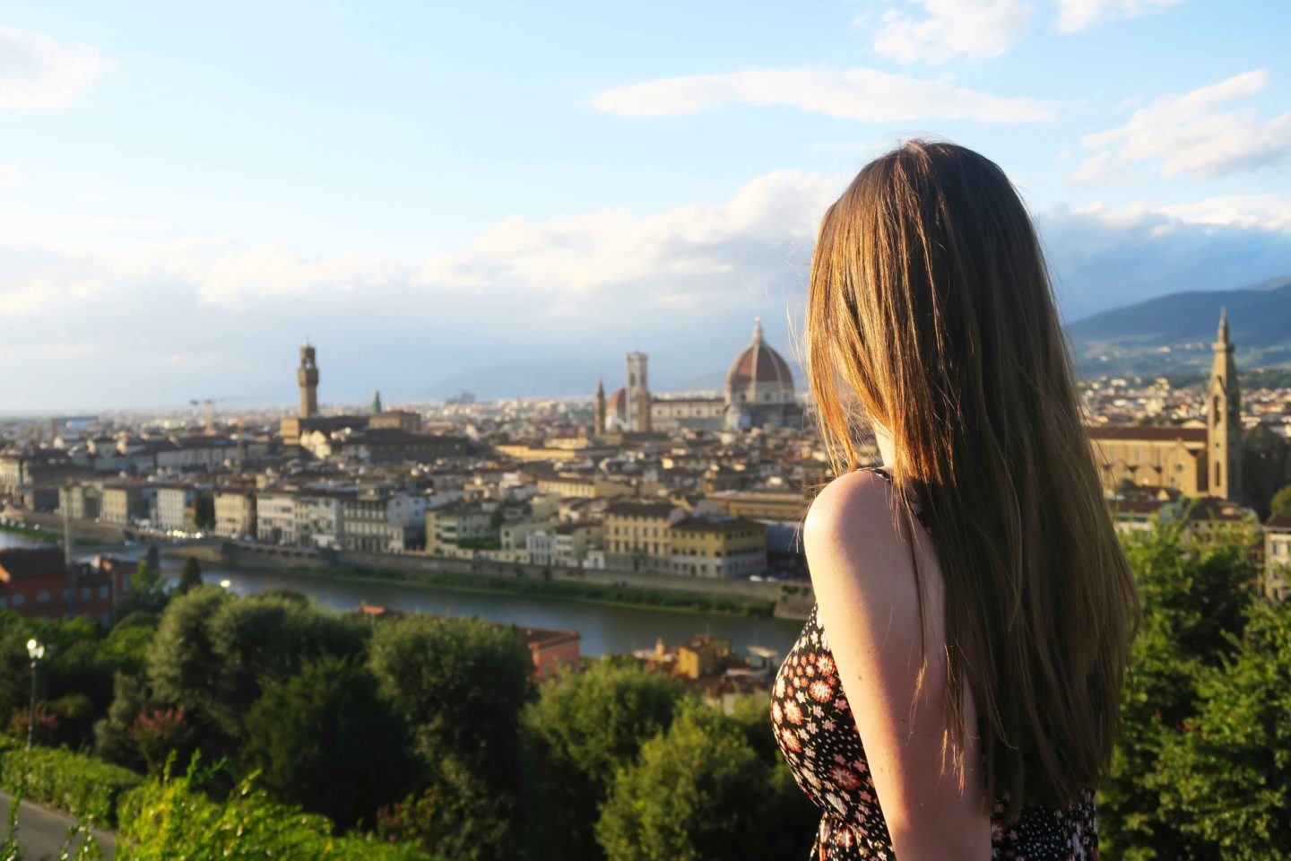 girl with brown hair looking our over the view of florence from piazzale michelangelo