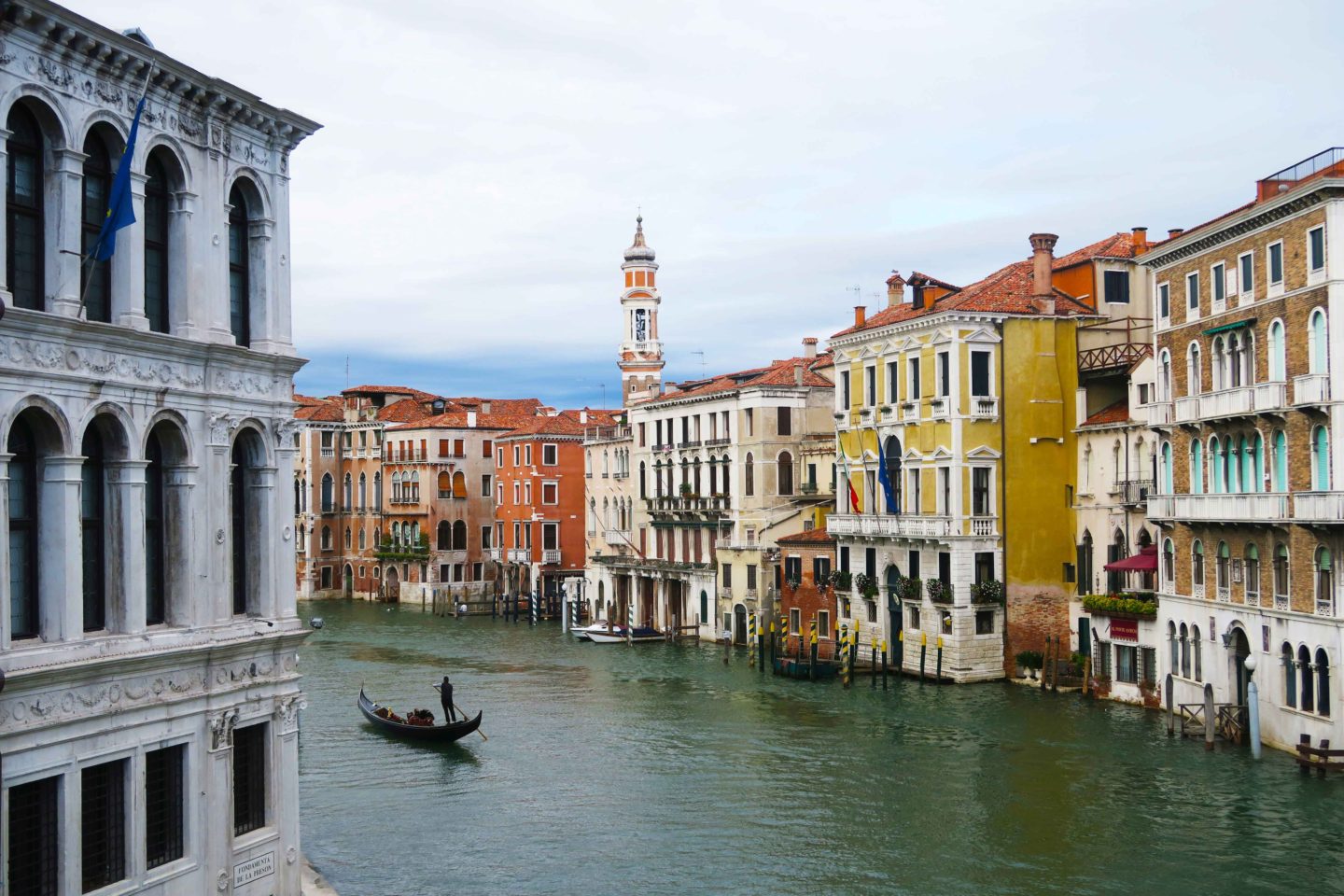 view from bridge in venice of a gondola in the canal
