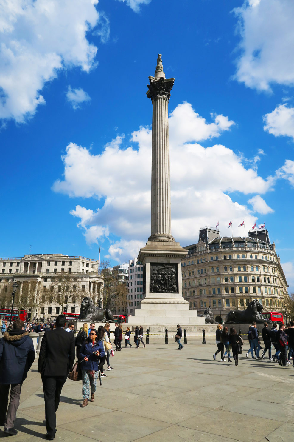 trafalgar square in london with blue sky and clouds