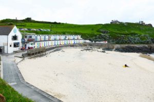 colourful beach huts in cornwall
