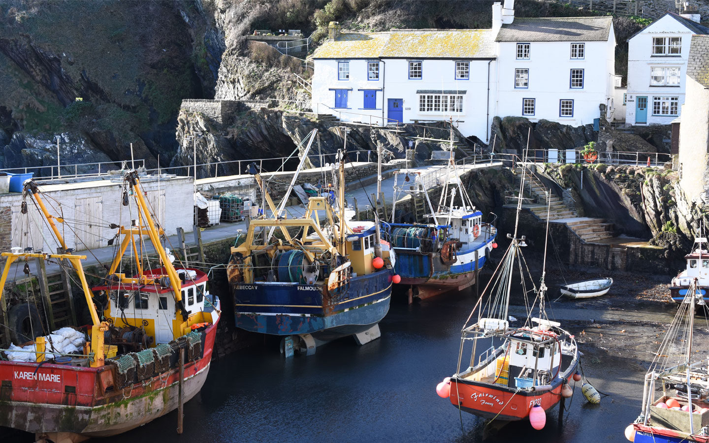 polperro harbour with fishing boats in