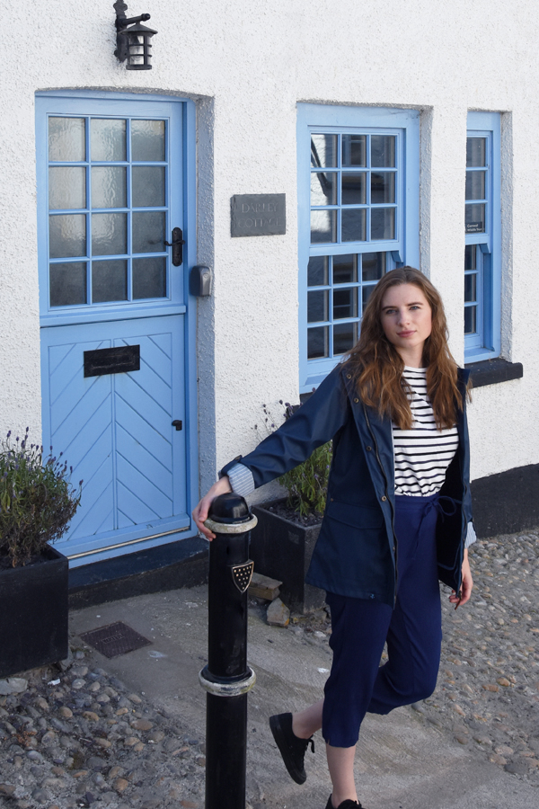 melissa carne wearing navy jacket in front of a cottage in looe in cornwall