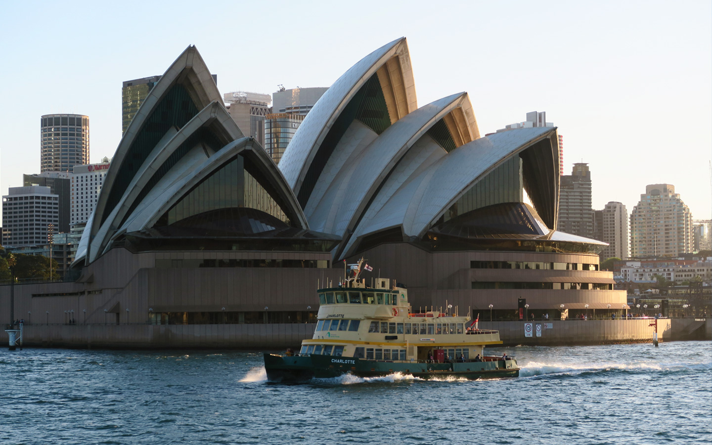 sydney opera house with ferry in front of it
