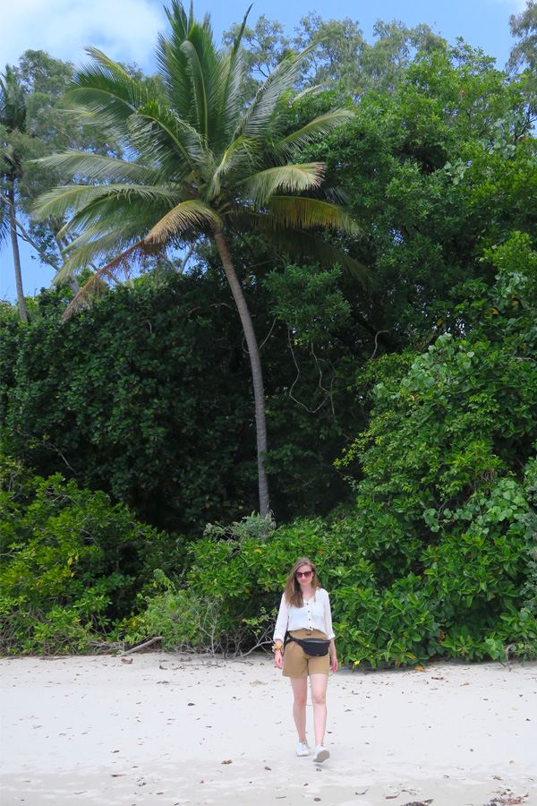 melissa carne on beach with palm tree at daintree rainforest in cape tribulation in australia
