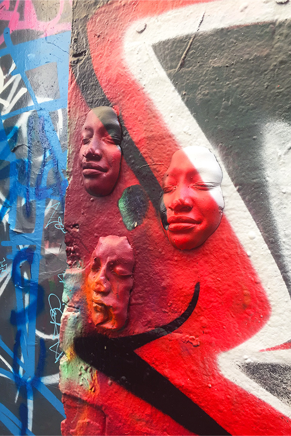 faces on graffiti wall in melbourne in australia