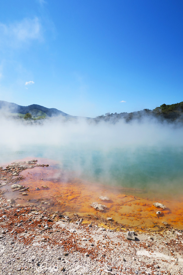 orange and blue geothermal area in waiotapu in new zealand
