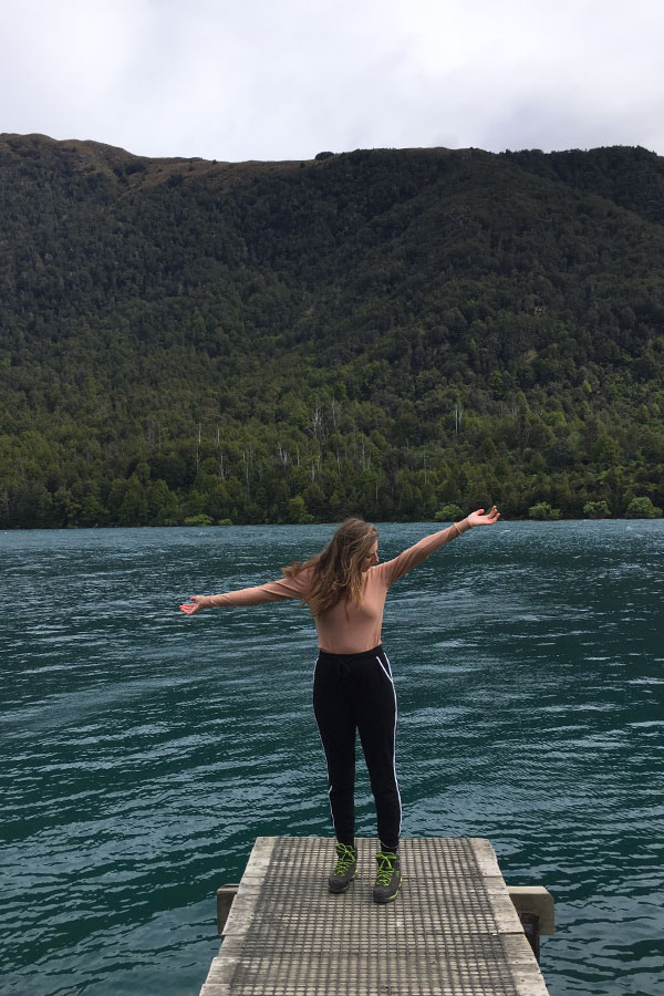 melissa carne standing on jetty at bob's cove in new zealand