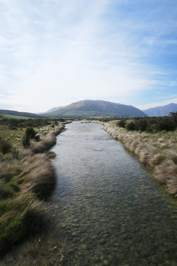 river running towards mountain at mount sunday in new zealand