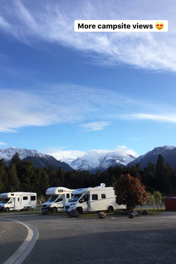 campervans parked in franz josef campsite in new zealand