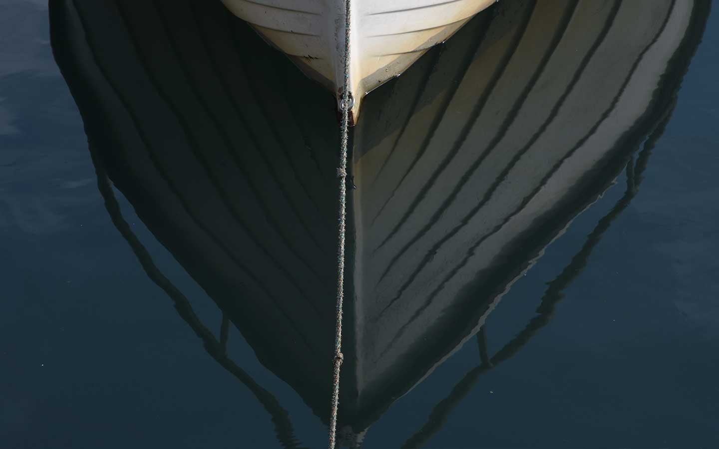 boat reflection in water in cornwall