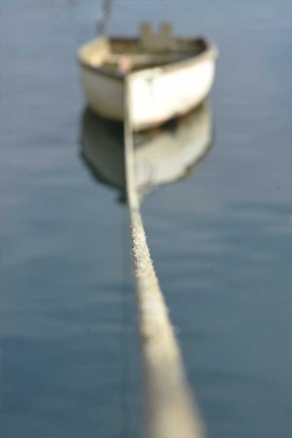 rope leading to fishing boat in cornwall